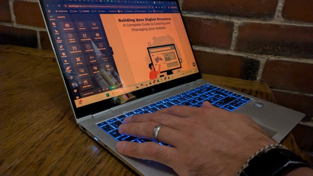 Hand typing out building your online presence on laptop